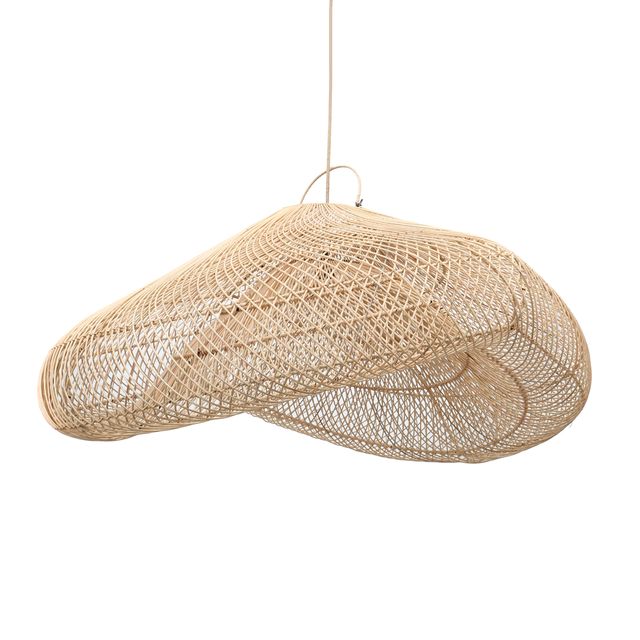 A woven natural-fiber pendant light hangs over a white cushioned wooden lounge chair in a bright, sunlit patio setting with plants, textured pillows, and rustic side tables.