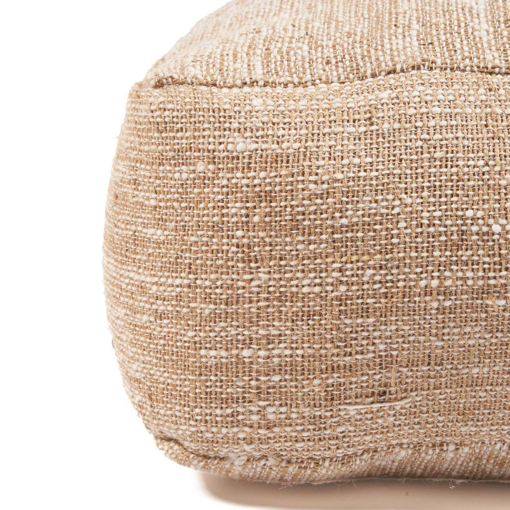Beige textured pouffe on a white background