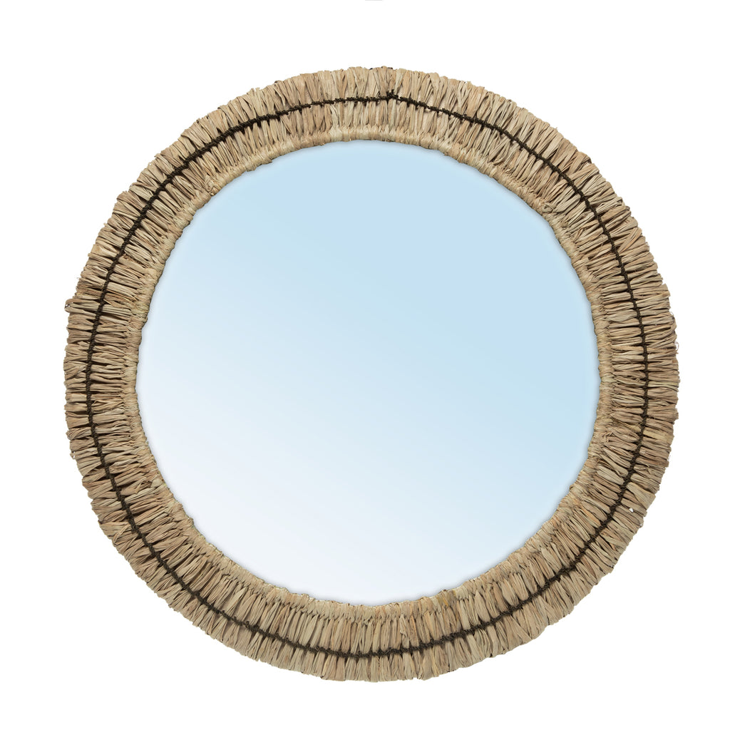 A beautifully styled bathroom interior featuring a round woven rattan mirror, a white ceramic vessel sink on a floating wooden vanity, and warm neutral-toned decor including woven baskets, a towel, and potted plants.