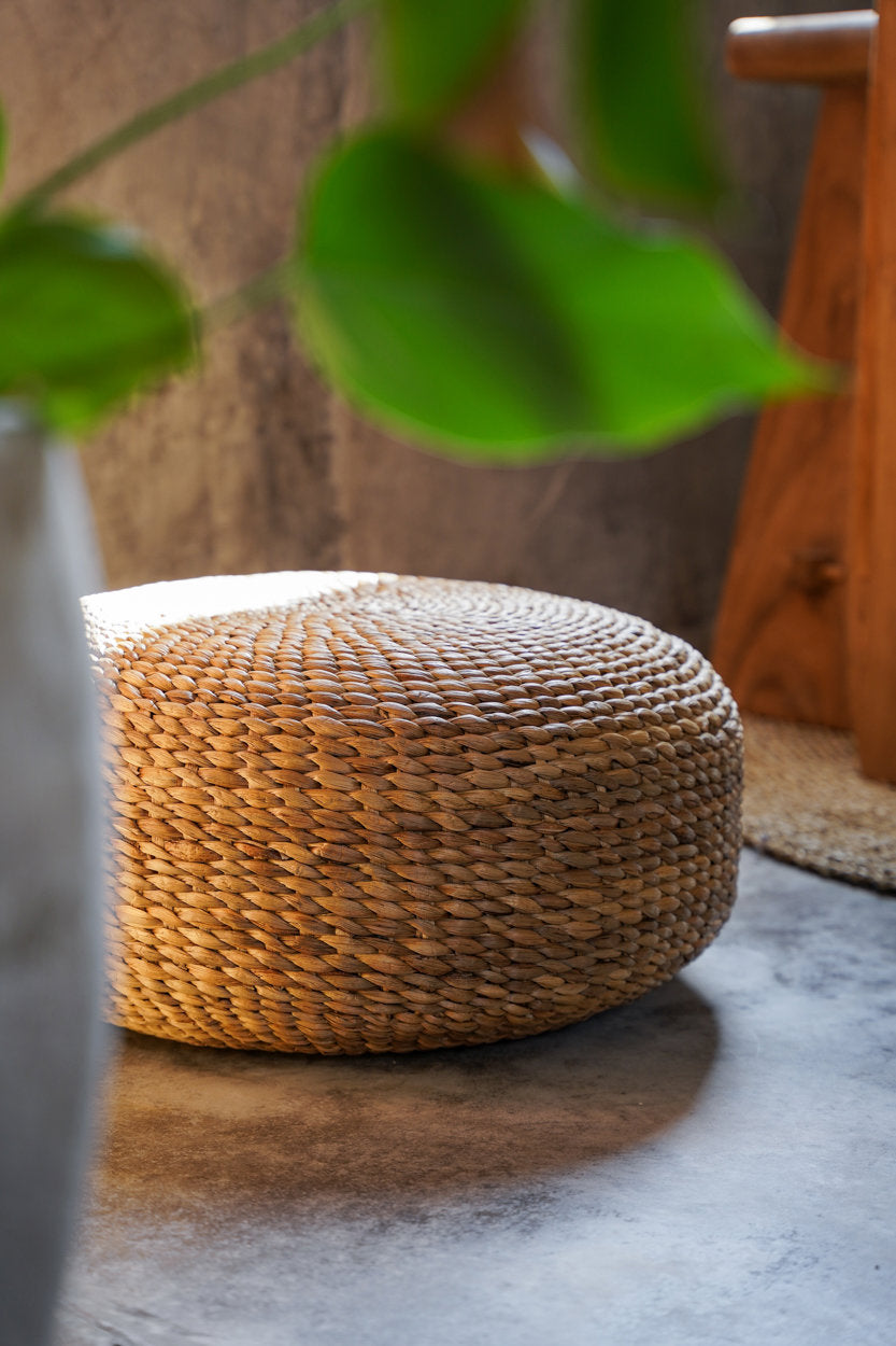 Woven beige pouffe on a white background