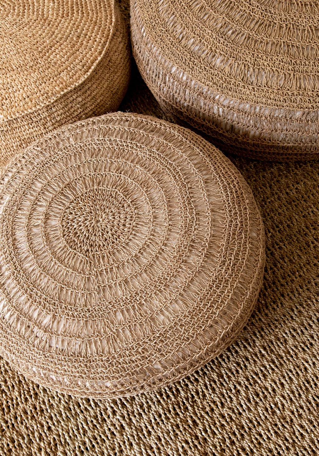 Round woven pouffe on a white background