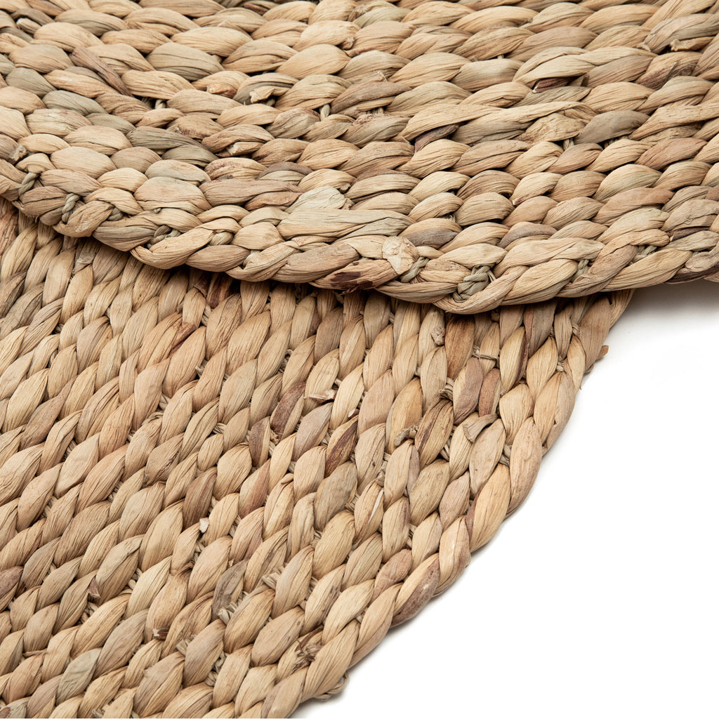 Round woven rug on a white background